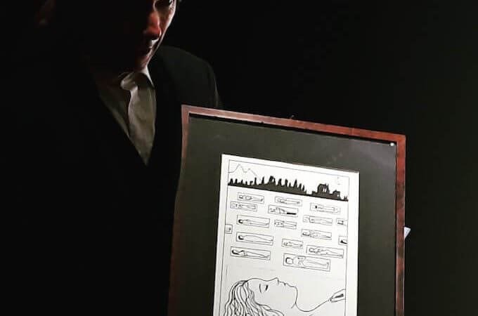 Paolo Valerio con una tavola di "Poema a fumetti"